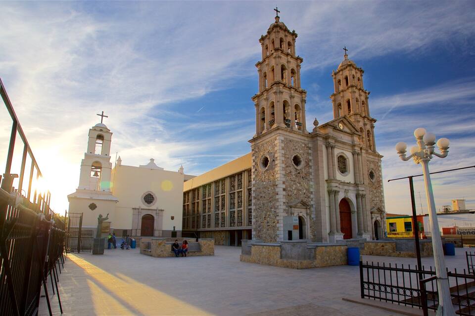 A historic church with two bell towers and a large arched window.