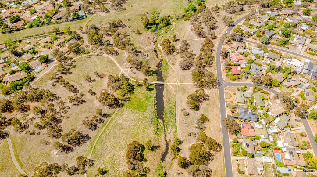 Aerial view of Umbagong District Park and Ginninderra Creek between the suburbs of Latham and Macgregor in Canberra, the Capital of Australia