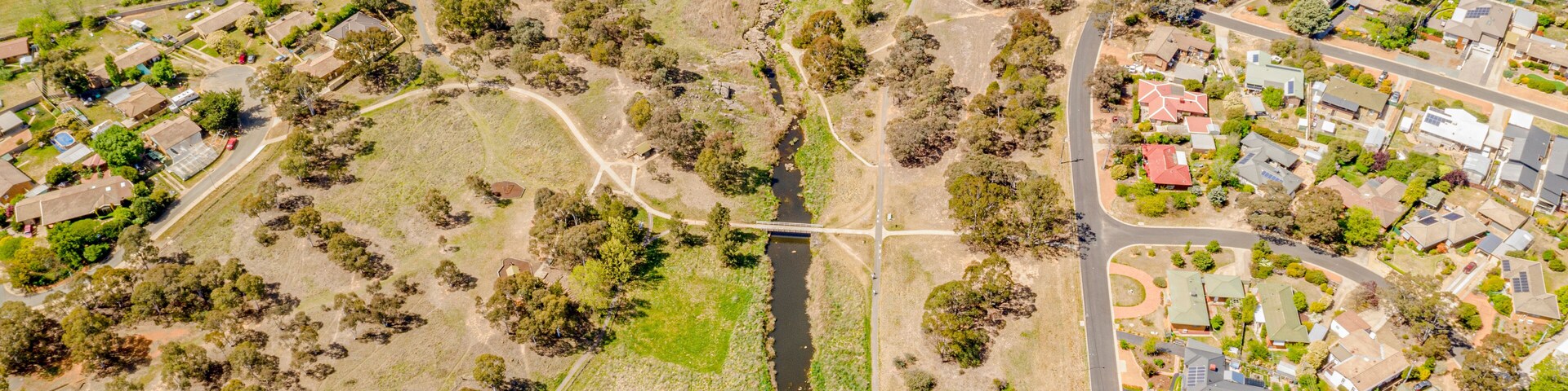 Aerial view of Umbagong District Park and Ginninderra Creek between the suburbs of Latham and Macgregor in Canberra, the Capital of Australia