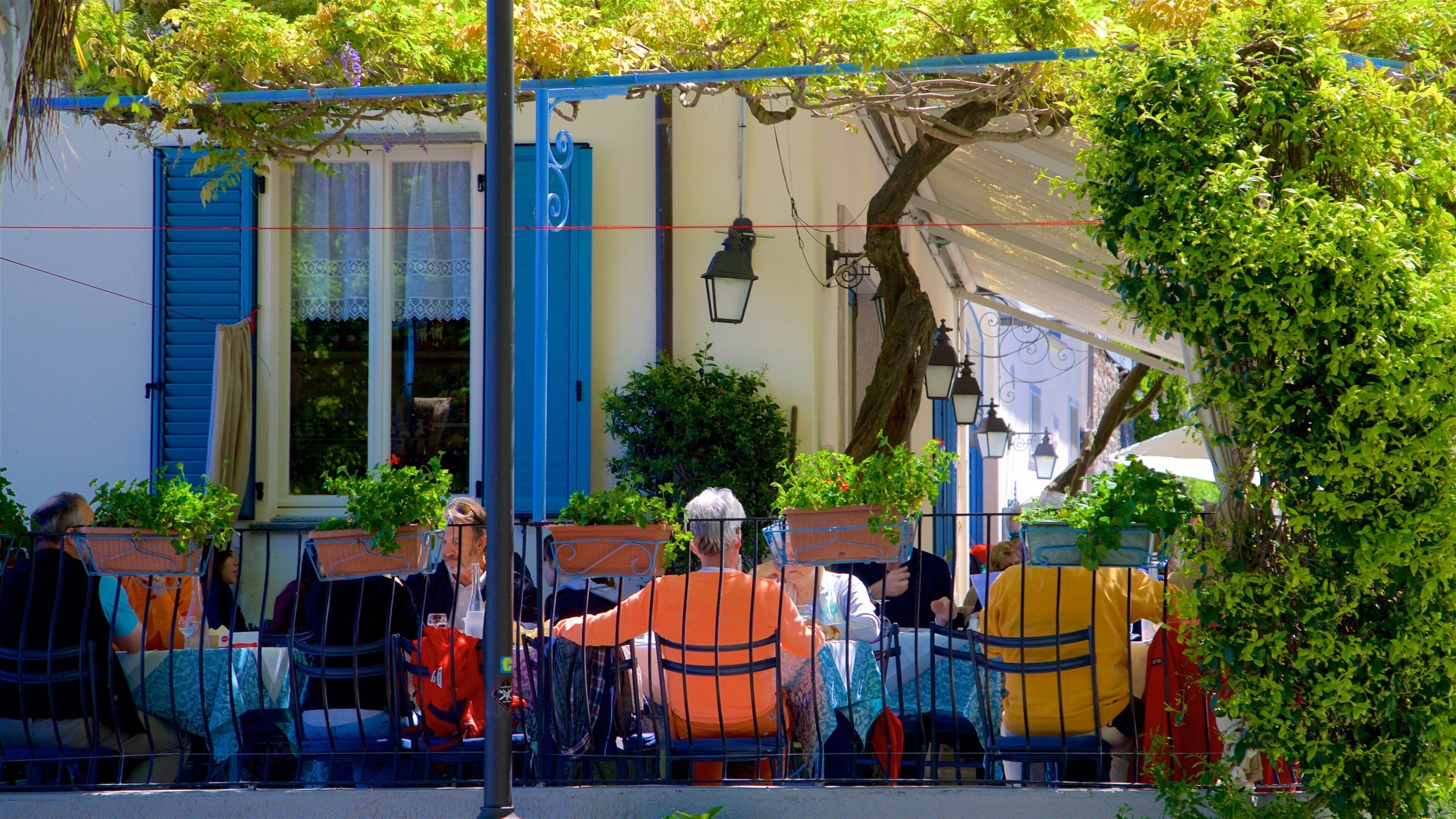 Isola dei Pescatori featuring outdoor eating as well as a small group of people