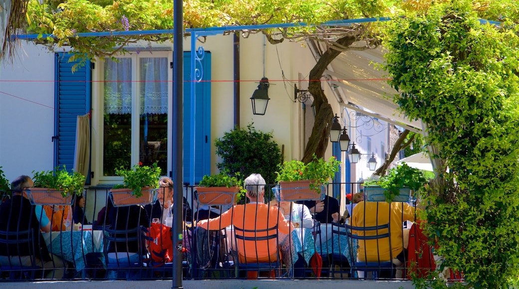 Isola dei Pescatori featuring outdoor eating as well as a small group of people