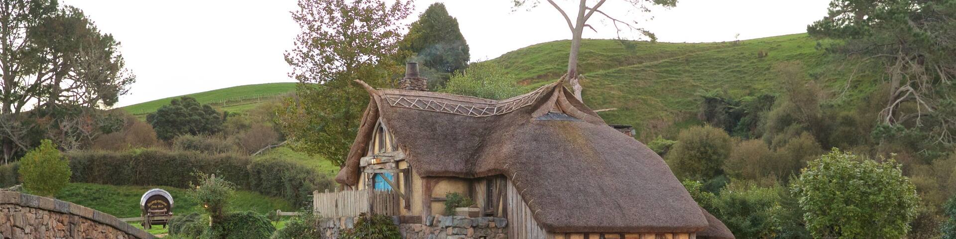Hobbiton Movie Set which includes a river or creek and a small town or village