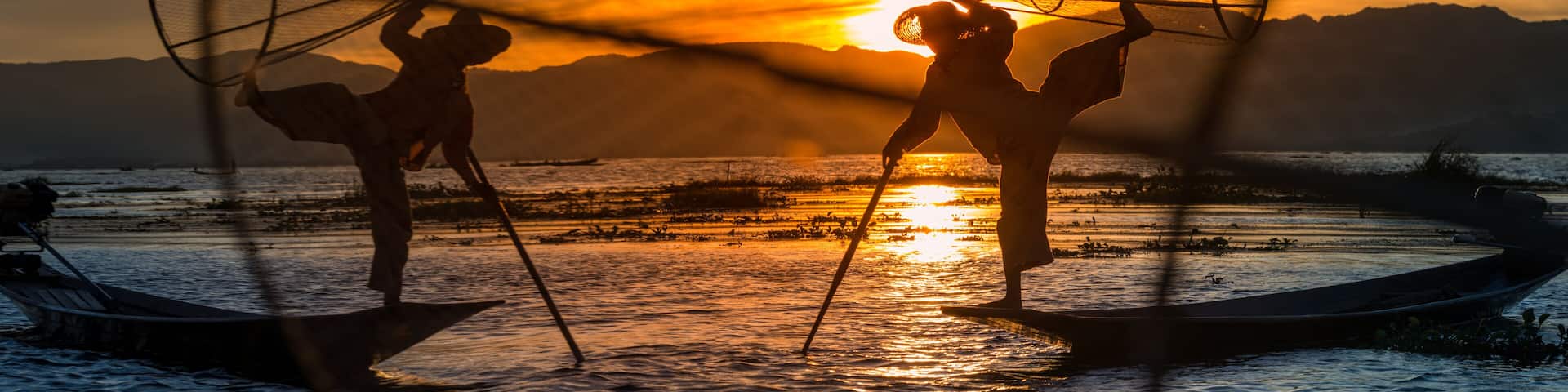 Burmese Fishermen posing with conical nets at sunset, Inle Lake in the Nyaungshwe Township part of Shan Hills in Myanmar Burma