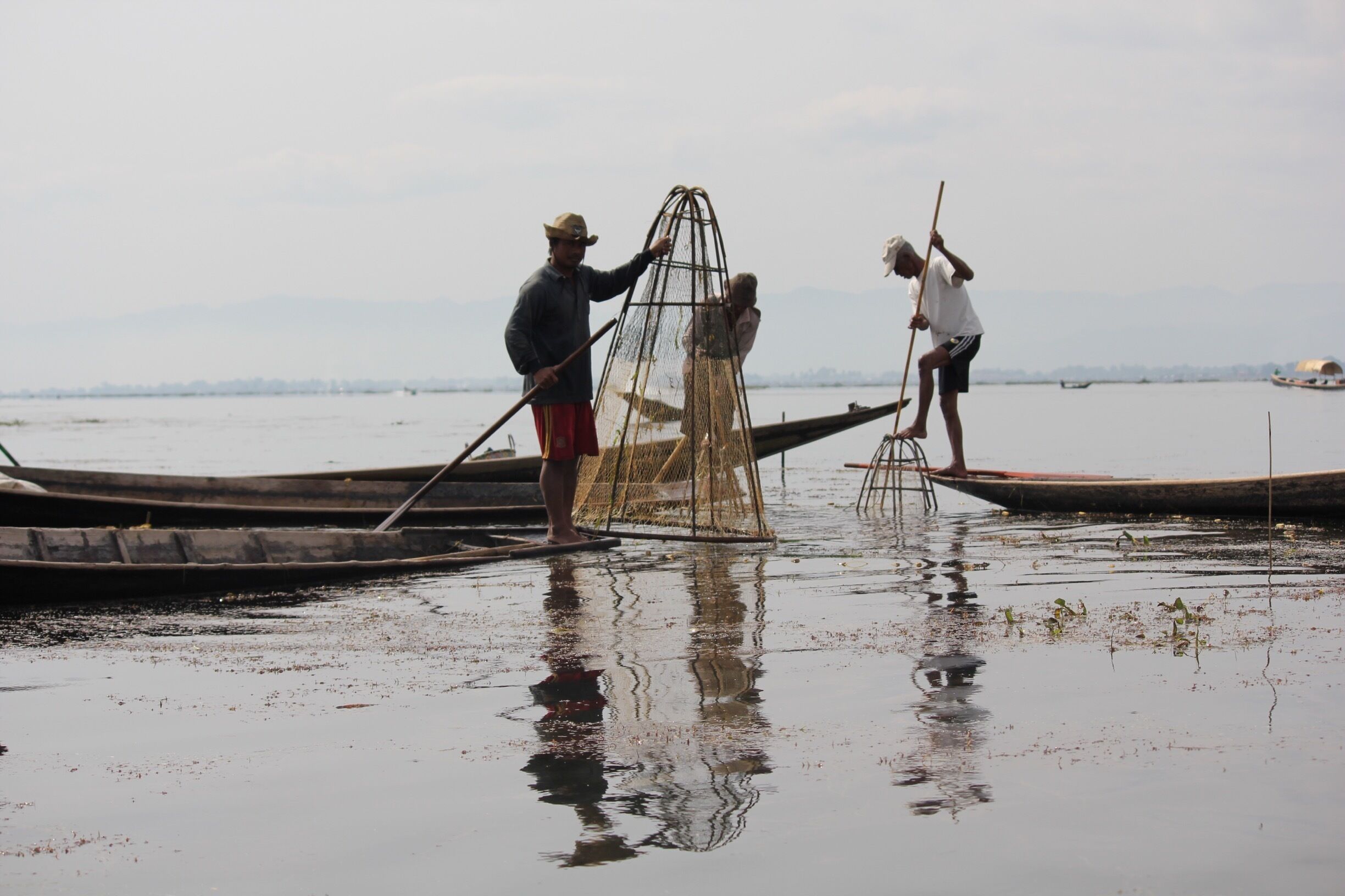 I have a series of shots of these fishermen, but this one won out because of the reflections.  If I remember correctly, about 90% of Myanmar's produce is grown on the lake.