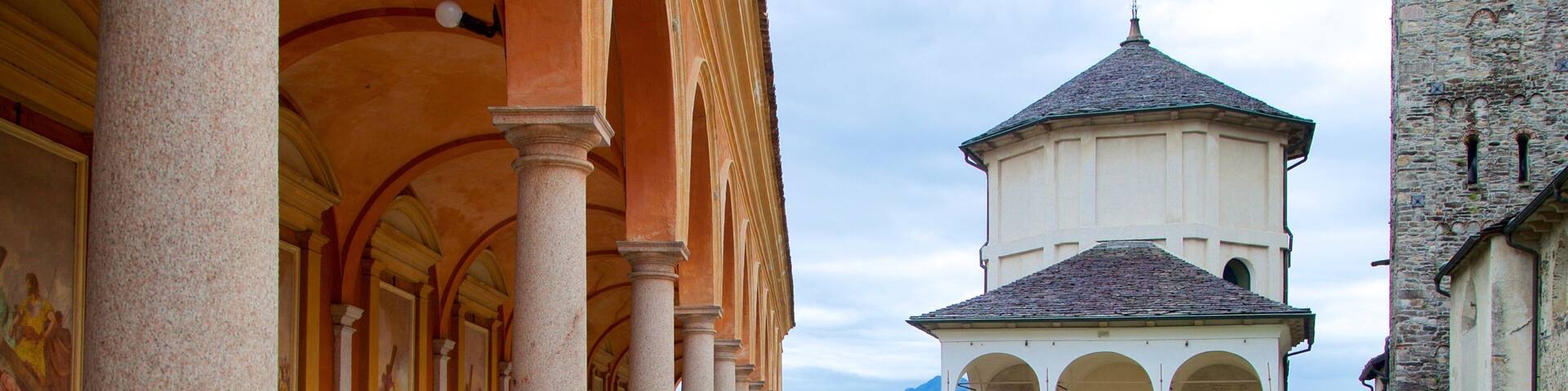 A church with a bell tower, columns, and a courtyard.