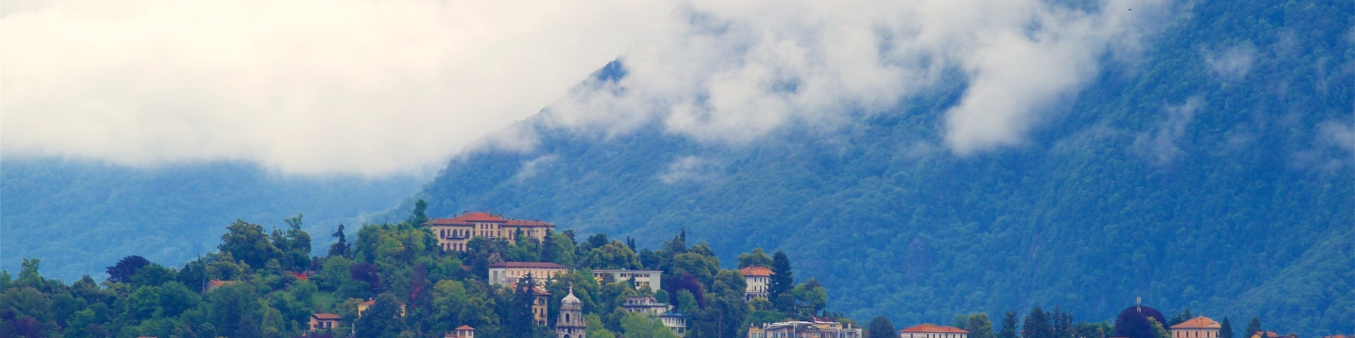Villa Fedora featuring a lake or waterhole, a small town or village and mountains