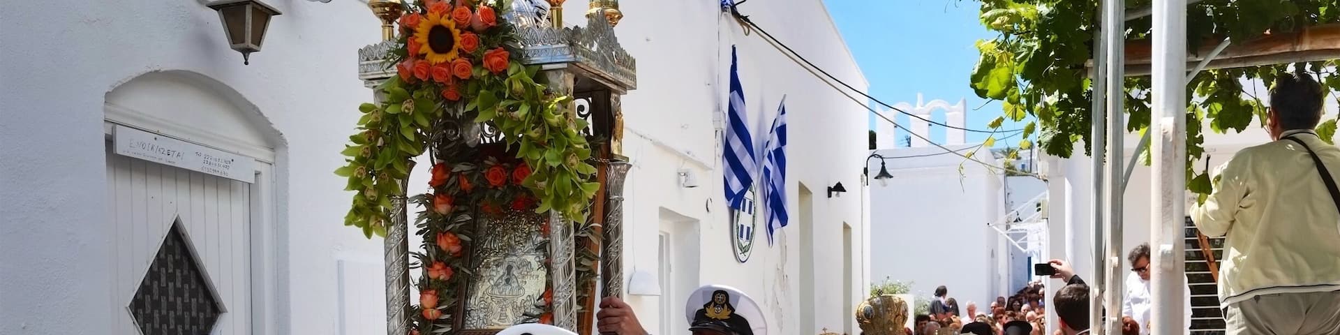 Apollonia ÎÏολλÏÎœÎŻÎ±, Sifnos. The biggest festival of all is that of the patron saint of the island, Panagia Chrysopigi, celebrated on Ascension Day, attended by many people from all over the island and beyond. In the afternoon of the day before, the miracle icon of Zoodochou Pigis (the Life-Giving Spring) is âtransportedâ from the home of the âpanigirasâ and the festival procession, with the clergy and the faithful, follows the path to the Holy Church of Agios Georgios in Kamares where the liturgy is held. Then the clergy, with the âpanigirasâ carrying the icon, board the ferry that each year on this day adds the sacred rock of Chrysopigi to its route from Piraeus. The ship does not carry the believers because disembarkation is potentially dangerous. The crowd of believers, local people and visitors, take the road to Chrissopigi where the arrival of the icon is greeted with great enthusiasm, and the celebrations are honoured by music of the Coast Guard band.