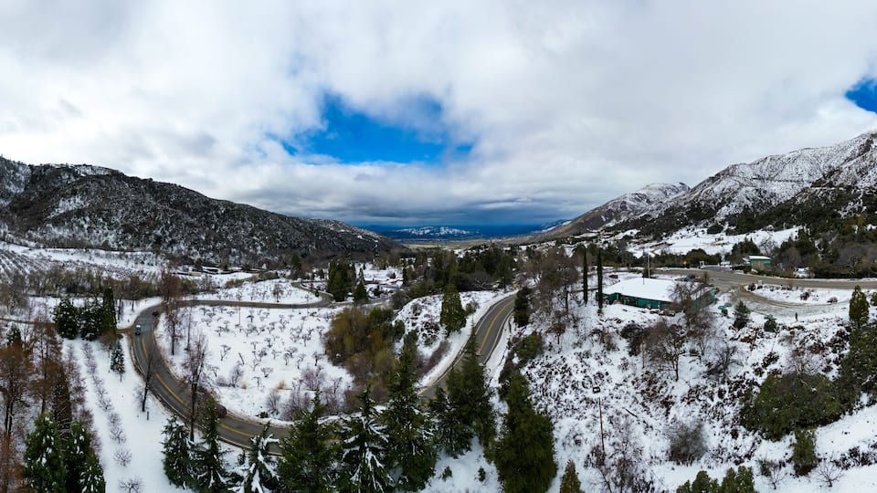 A UAV Drone Aerial Panoramic View of Oak Glen, California, after a major Winter Storm with Snow on the Ground