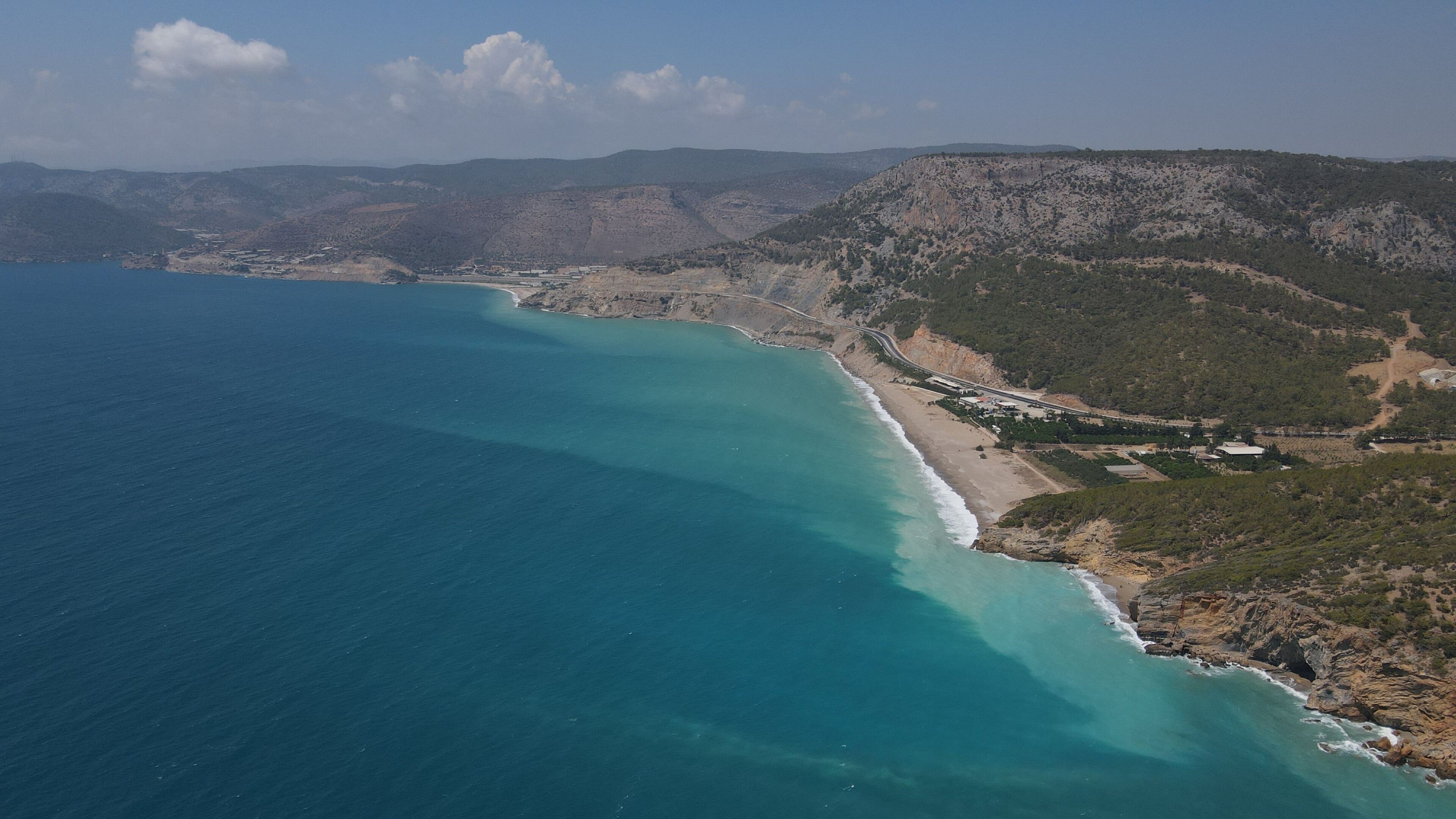 Aerial shot of a blue sea in Yanisli Cave Beach, Gulnar, Mersin, Turkey