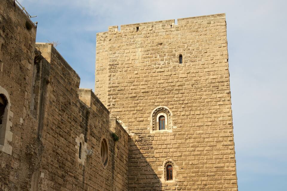 A historic stone tower with arched windows and a crenellated top.