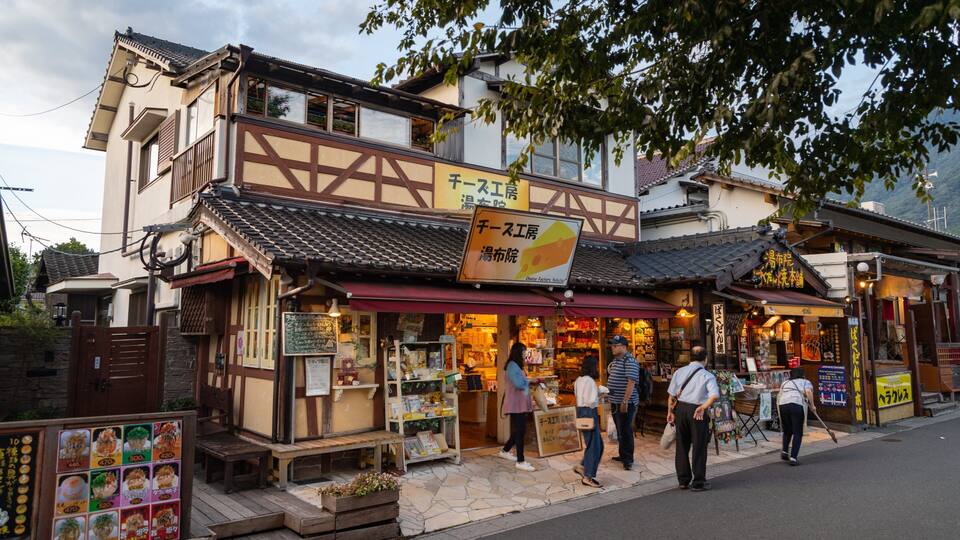 A traditional Japanese building with a sign for a cheese factory.