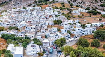 Pueblo blanco y bullicioso con edificios escalonados en una ladera.