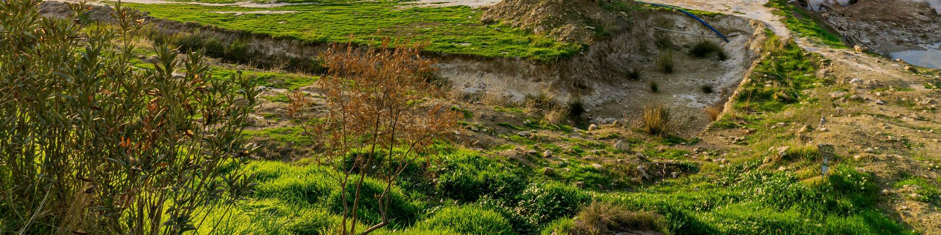 cenic views of thermal springs and mud bath in Sarayköy which contains bicarbonates and sulfates and power plant producing electricity from the geothermal steam, Denizli, Turkey