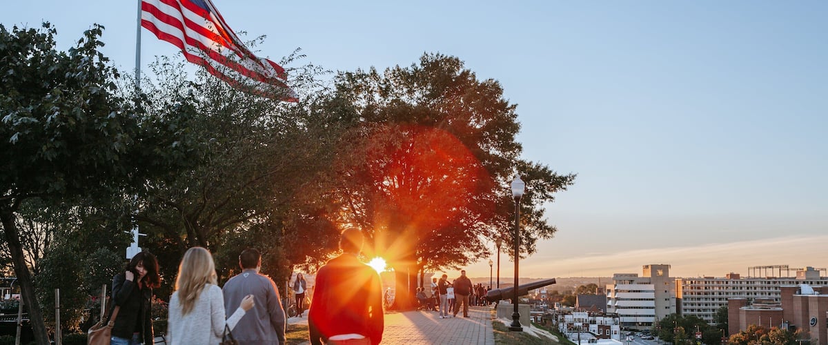 Federal Hill Park showing a sunset and a garden as well as a couple