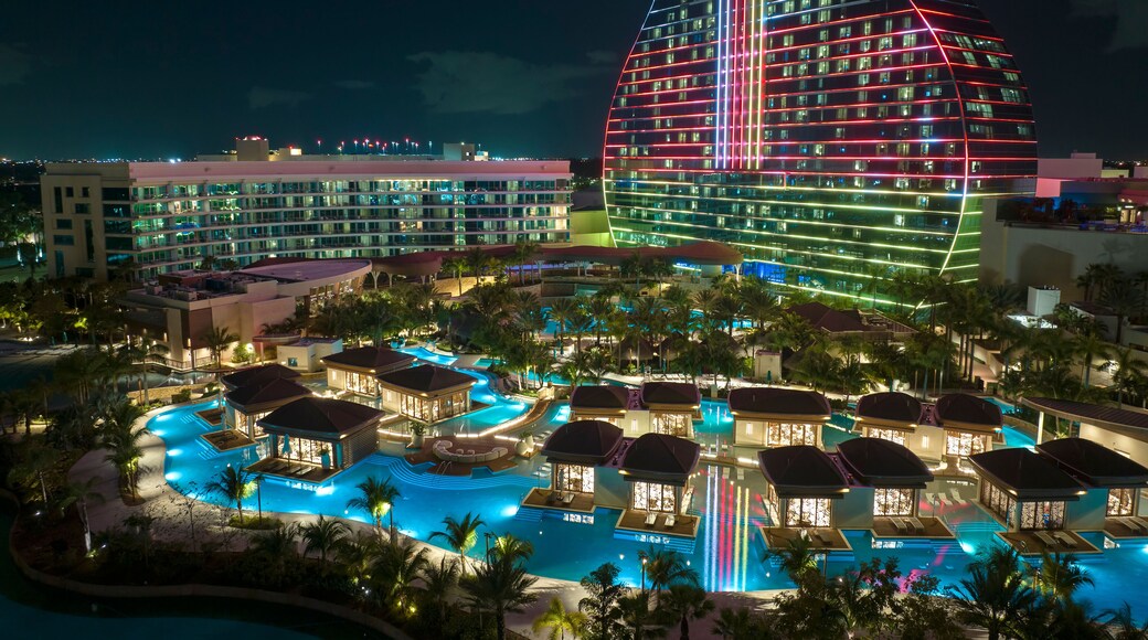 Aerial view of guitar shaped Seminole Hard Rock Hotel and Casino structure illuminated with bright neon colorful lights in Hollywood, Florida