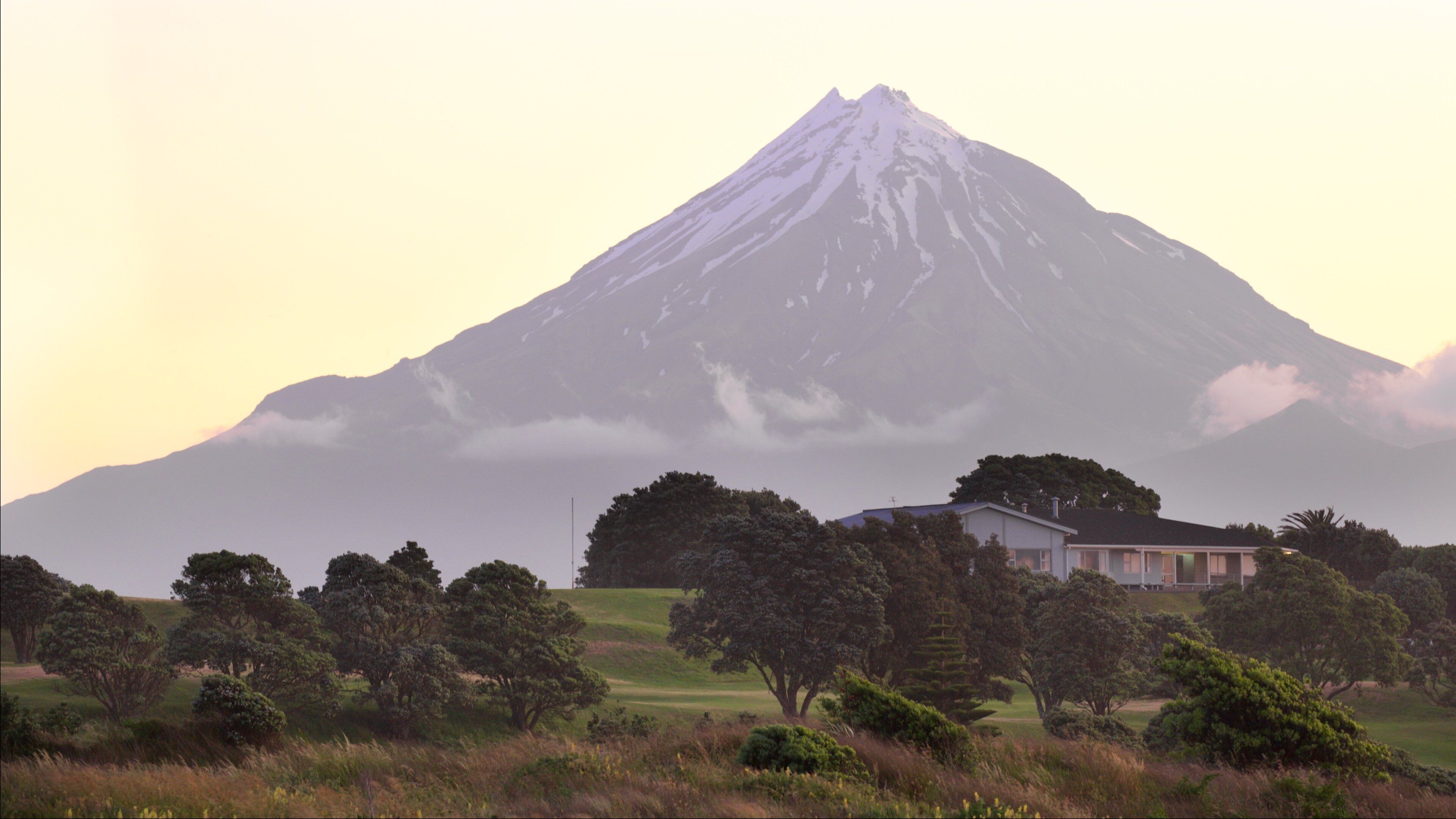 Fitzroy Beach which includes mountains, tranquil scenes and a sunset