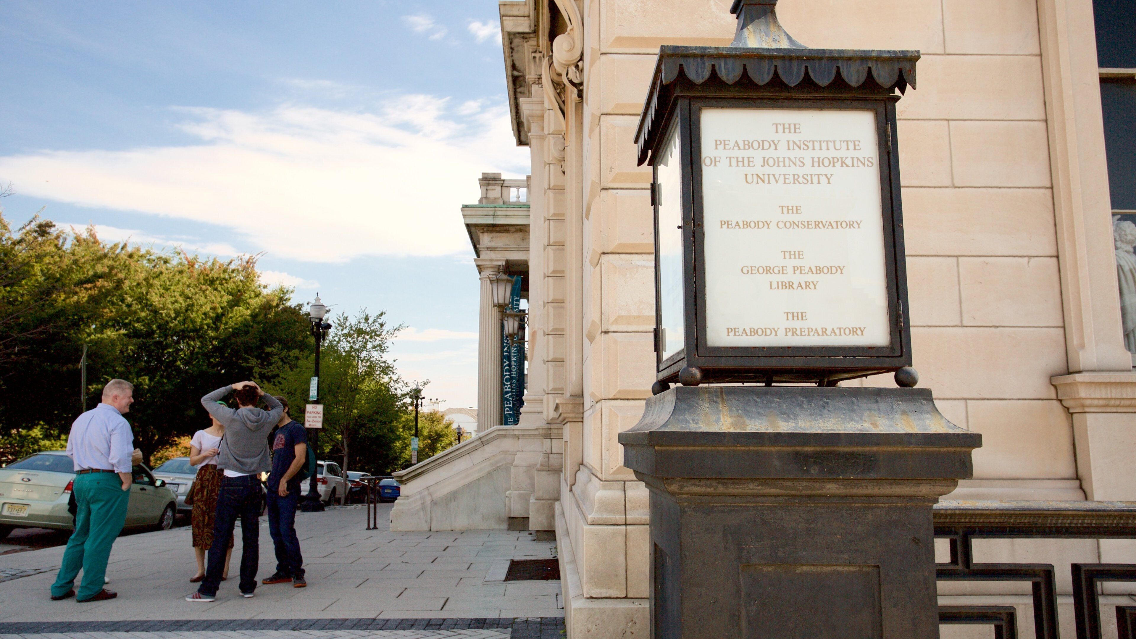 Peabody Institute of the John Hopkins University which includes signage as well as a small group of people
