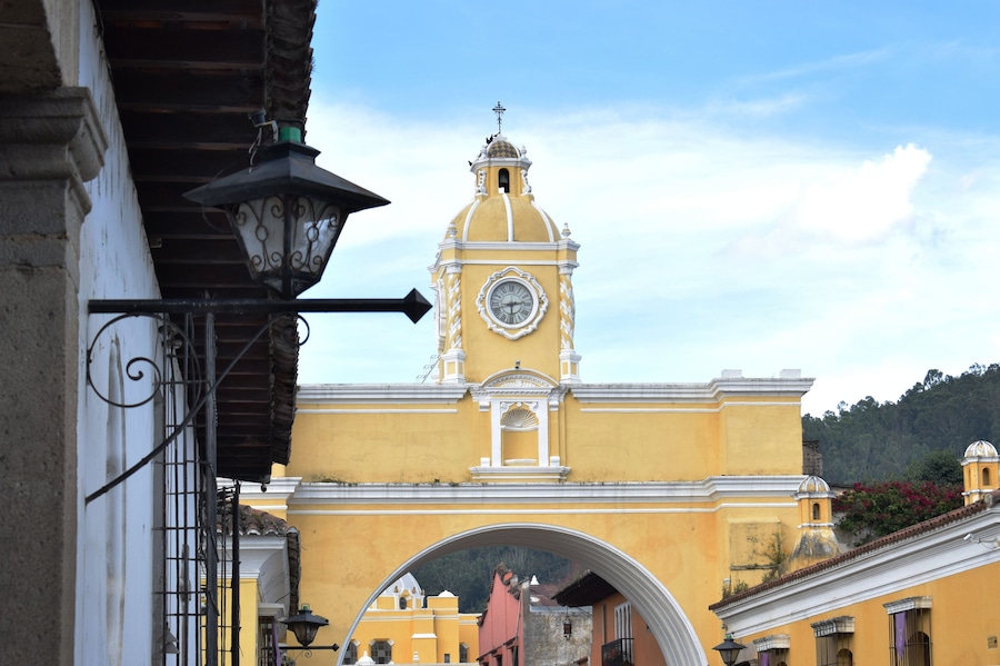 A yellow building with a clock tower and a dome.
