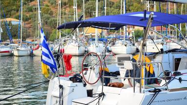 A marina with multiple sailboats docked.