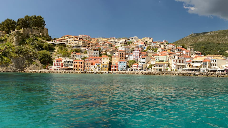A coastal town with colorful buildings on a hillside overlooking turquoise waters.