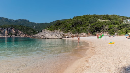 Panorama of beautiful Rovinia Beach with turquoise water and rocks during summer vacations, Corfu, Greece