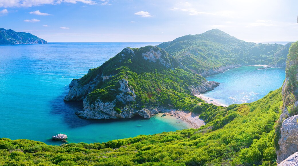 Beautiful summertime panoramic seascape. View of the cliff into the crystal clear azure sea bay and distant islands. Unique secluded beach. Agios Stefanos cape. Afionas. Corfu. Greece.