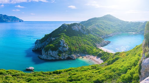 Beautiful summertime panoramic seascape. View of the cliff into the crystal clear azure sea bay and distant islands. Unique secluded beach. Agios Stefanos cape. Afionas. Corfu. Greece.