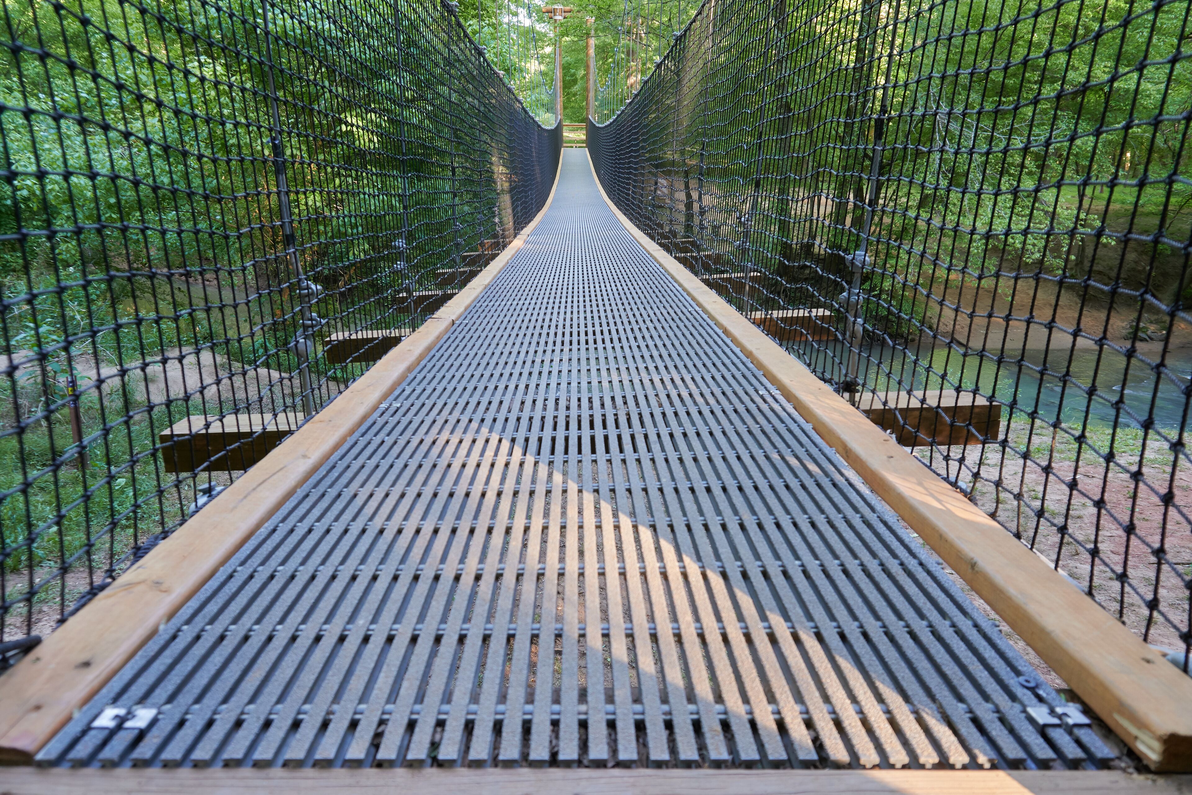 FORT MILL, SOUTH CAROLINA/UNITED STATES – APRIL 27, 2019: Suspension bridge at Anne Springs Close Greenway in Fort Mill, South Carolina.    