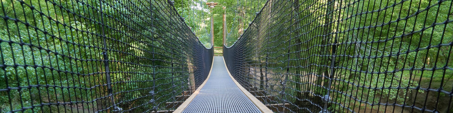 FORT MILL, SOUTH CAROLINA/UNITED STATES – APRIL 27, 2019: Suspension bridge at Anne Springs Close Greenway in Fort Mill, South Carolina.