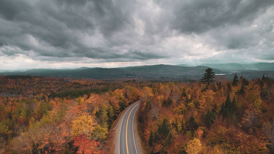 Road in the mountains with autumn color, in Abbot, Maine