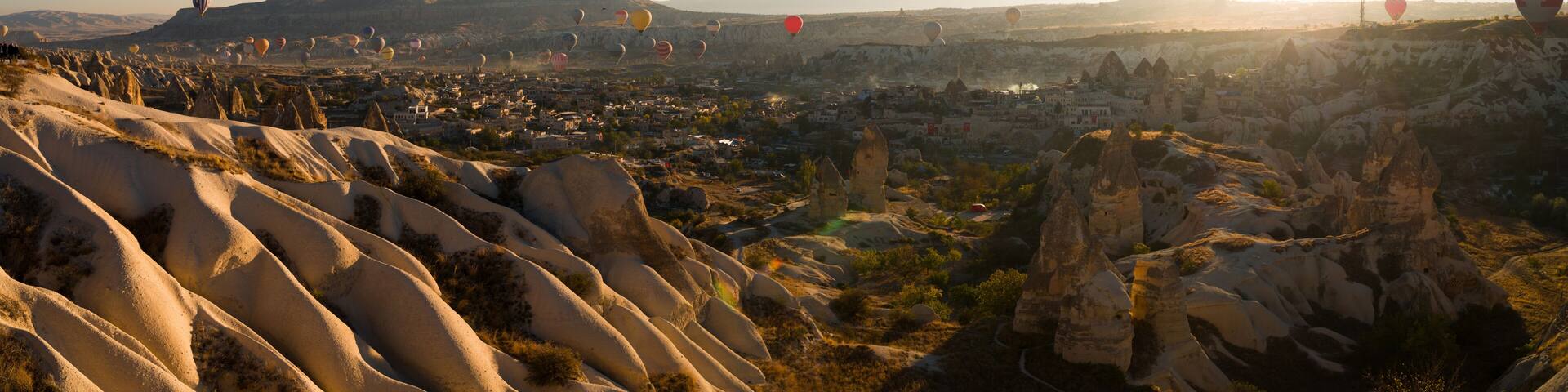Hot air balloon tour over Goreme open air museum and Cappadocia fairy chimneys. Morning panoramic magical view of Cappadocia. Turkey's UNESCO listed tourism symbols. Nevsehir city, country of Turkey