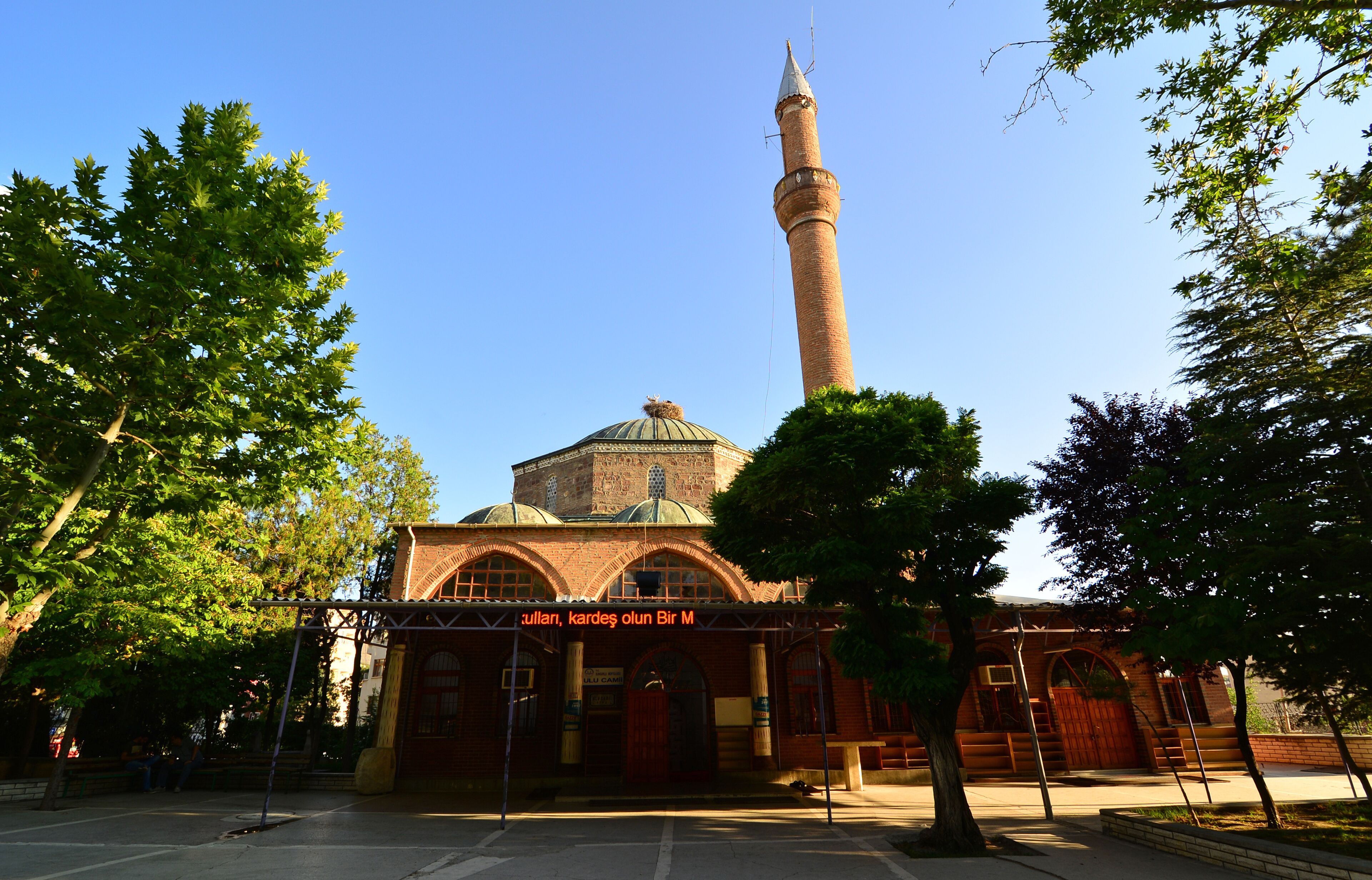 A historic building with a prominent minaret and a dome.
