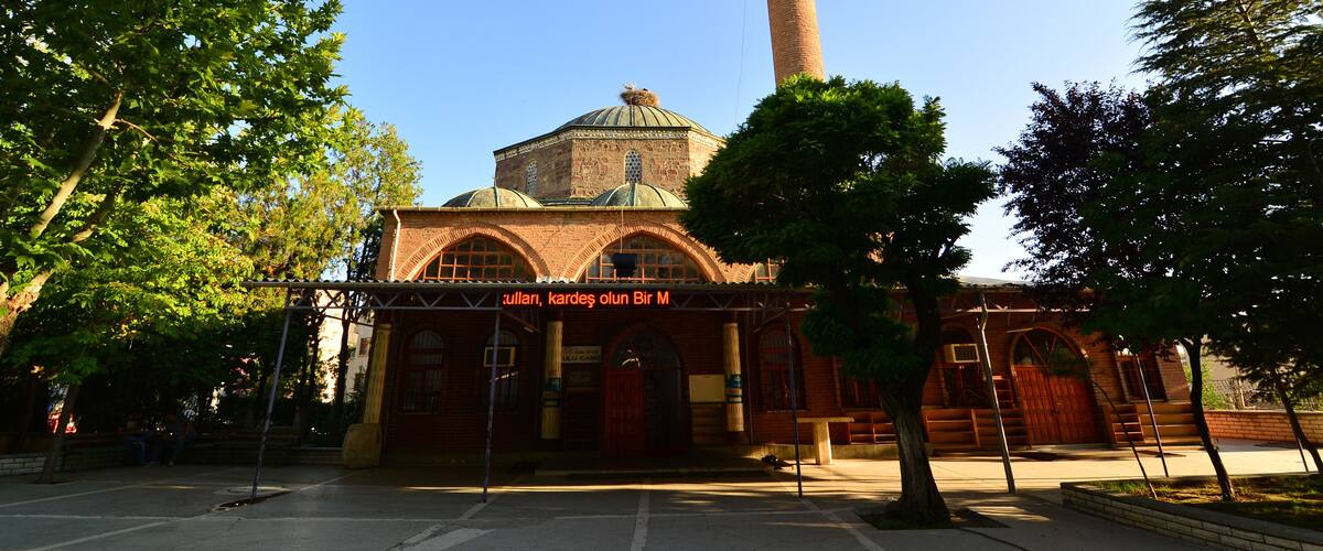 A historic building with a prominent minaret and a dome.