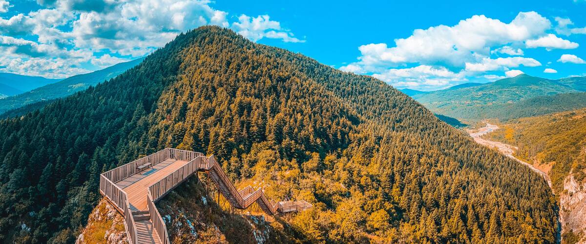 A forested mountain with a wooden viewing platform.