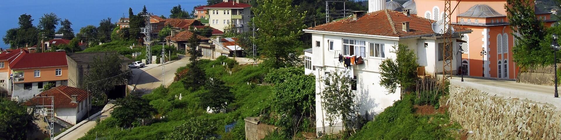 TRABZON, TURKEY - JUNE 28, 2008: Yeniay Village, Mosque and Black Sea. Surmene District