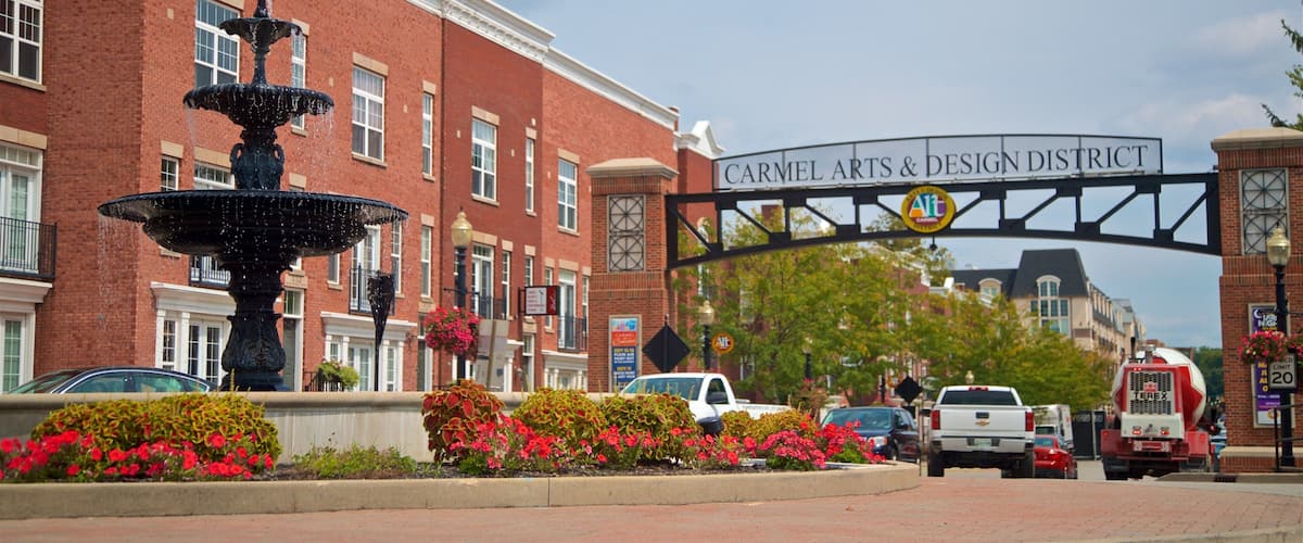 Carmel Arts and Design District featuring signage, flowers and a fountain