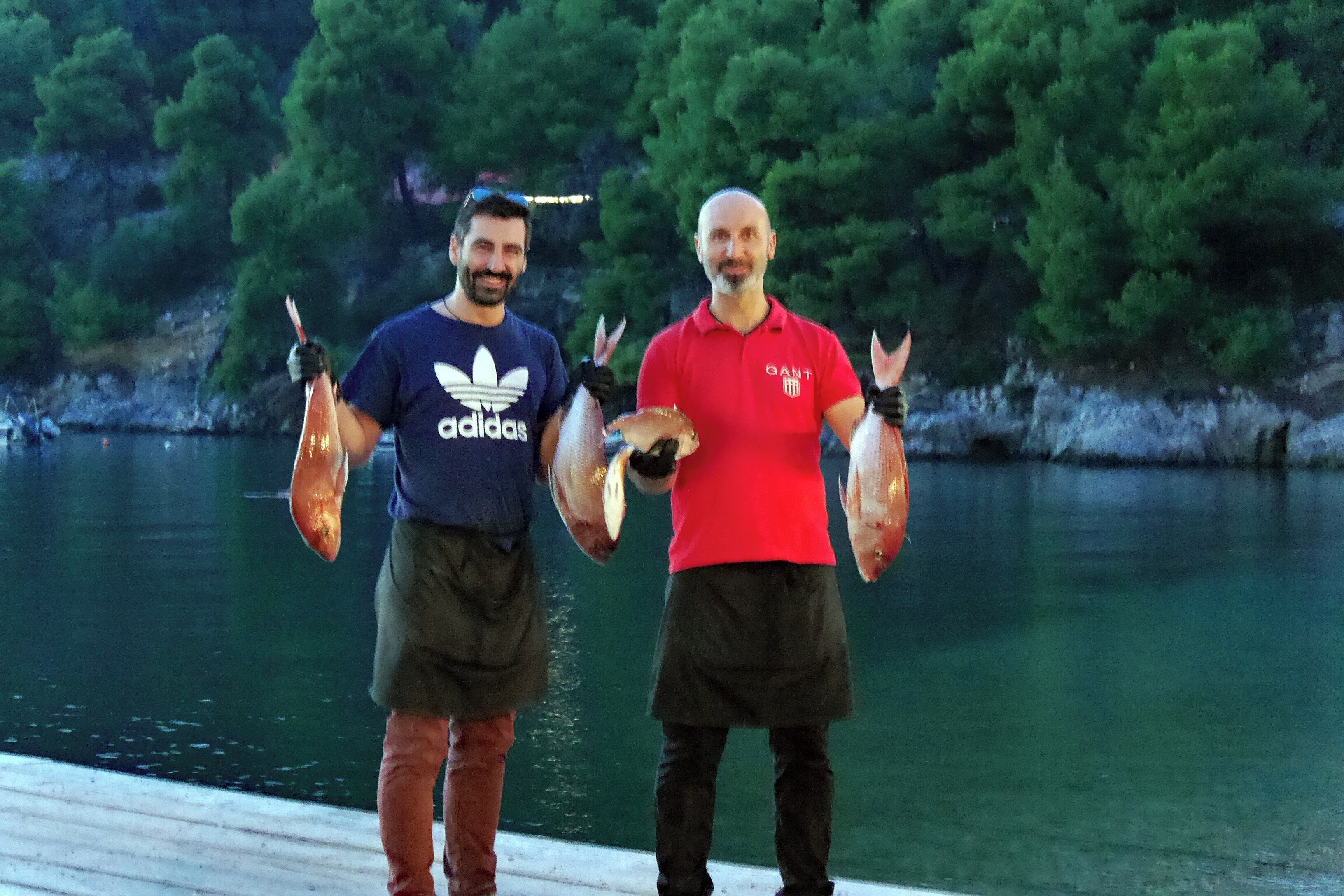 Never had fish fresher!  The beautiful small harbour & fishing port of Agnondas on the stunning island of Skopelos has three lovely harbourside tavernas. Together with local traditional Greek dishes you can enjoy fish straight out of the sea. 
Here two guys from one of the tavernas have walked to the end of the little wooden jetty and collected these fresh fish straight from the fisherman. 
Later in the evening, once they have been cleaned and prepared, they will be on someones plate!
#GoodEats