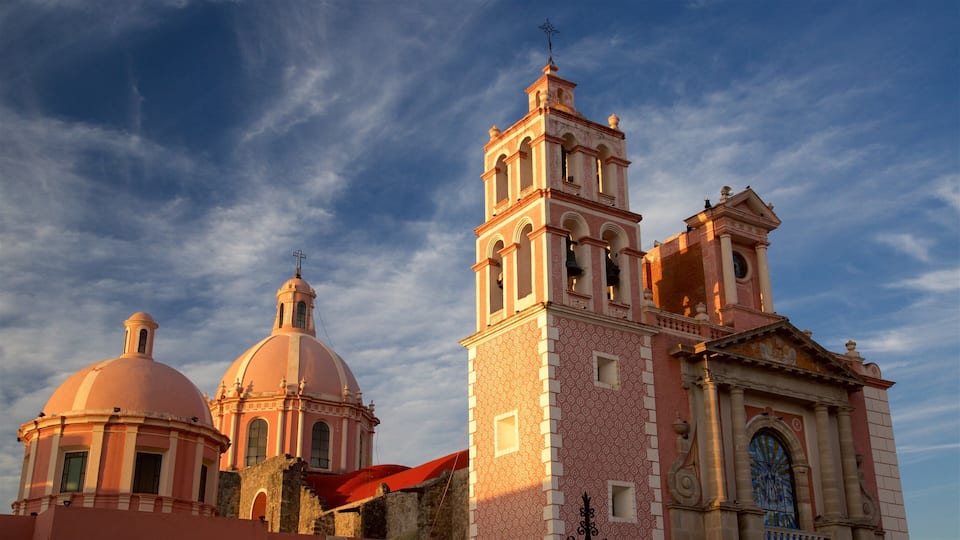 A church with two domes and a bell tower.