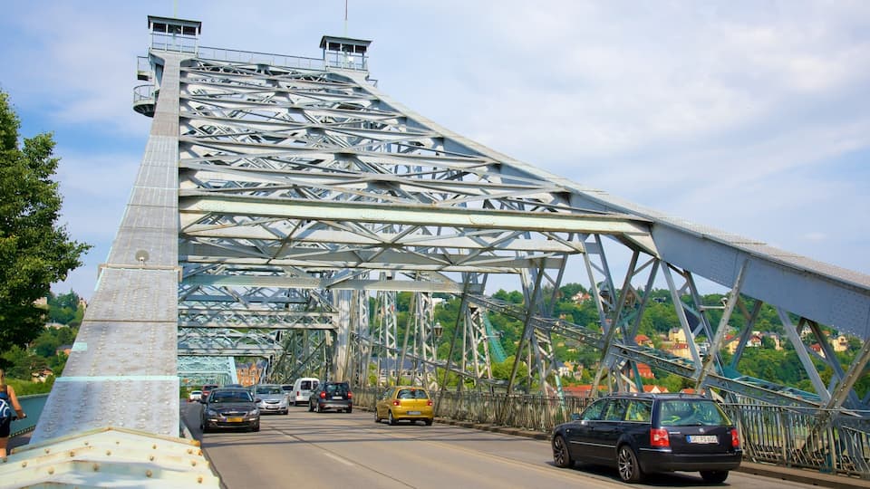 A steel bridge with cars driving on it.