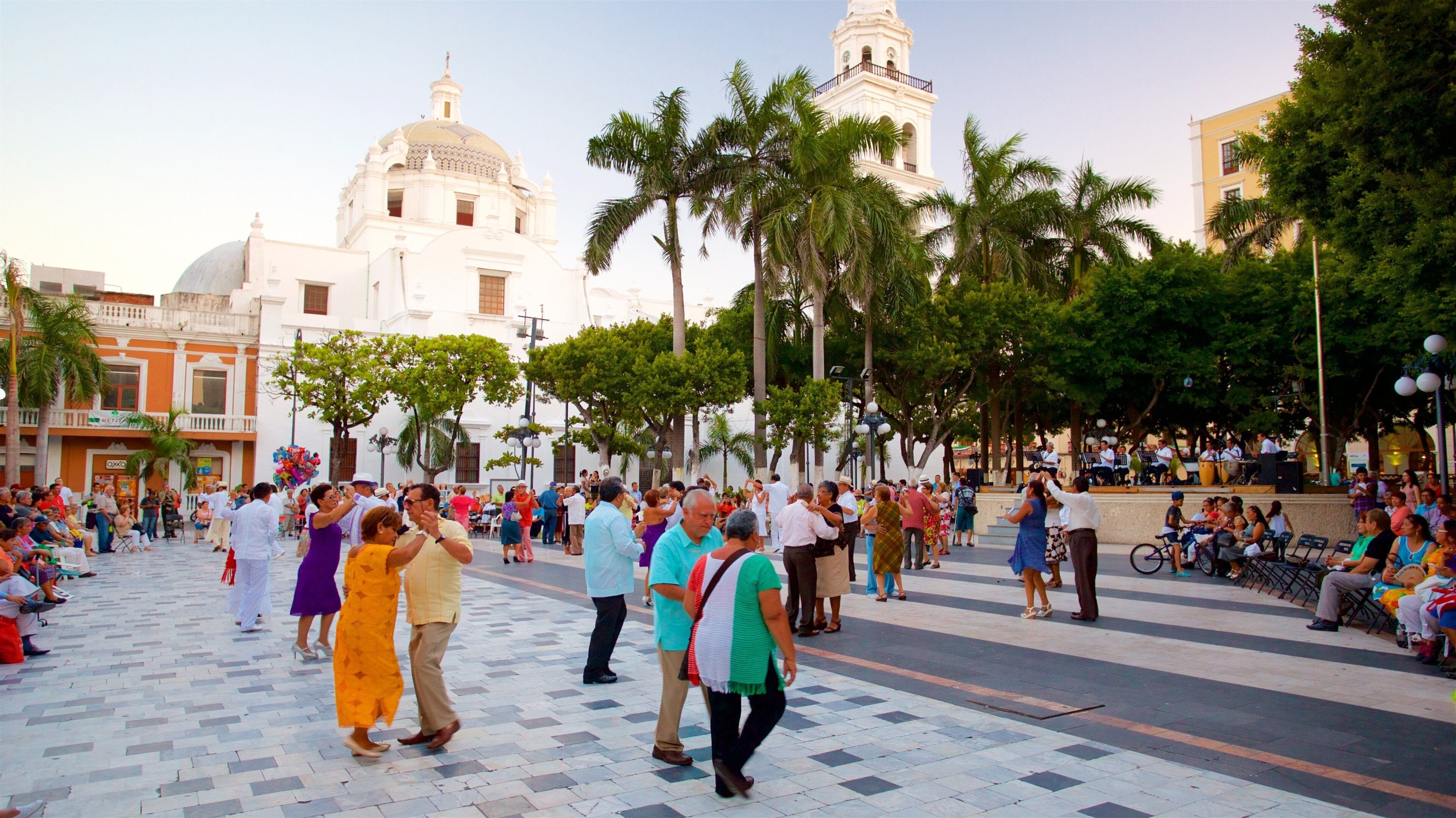 Veracruz Cathedral featuring heritage elements and a square or plaza as well as a small group of people