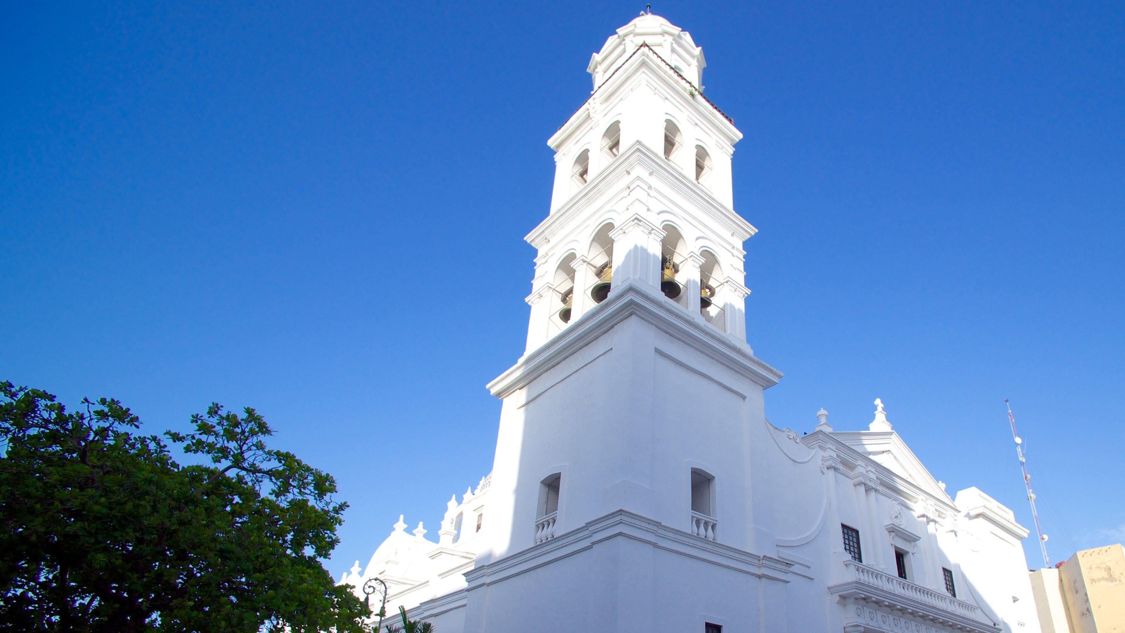 A white church with a bell tower and a dome.