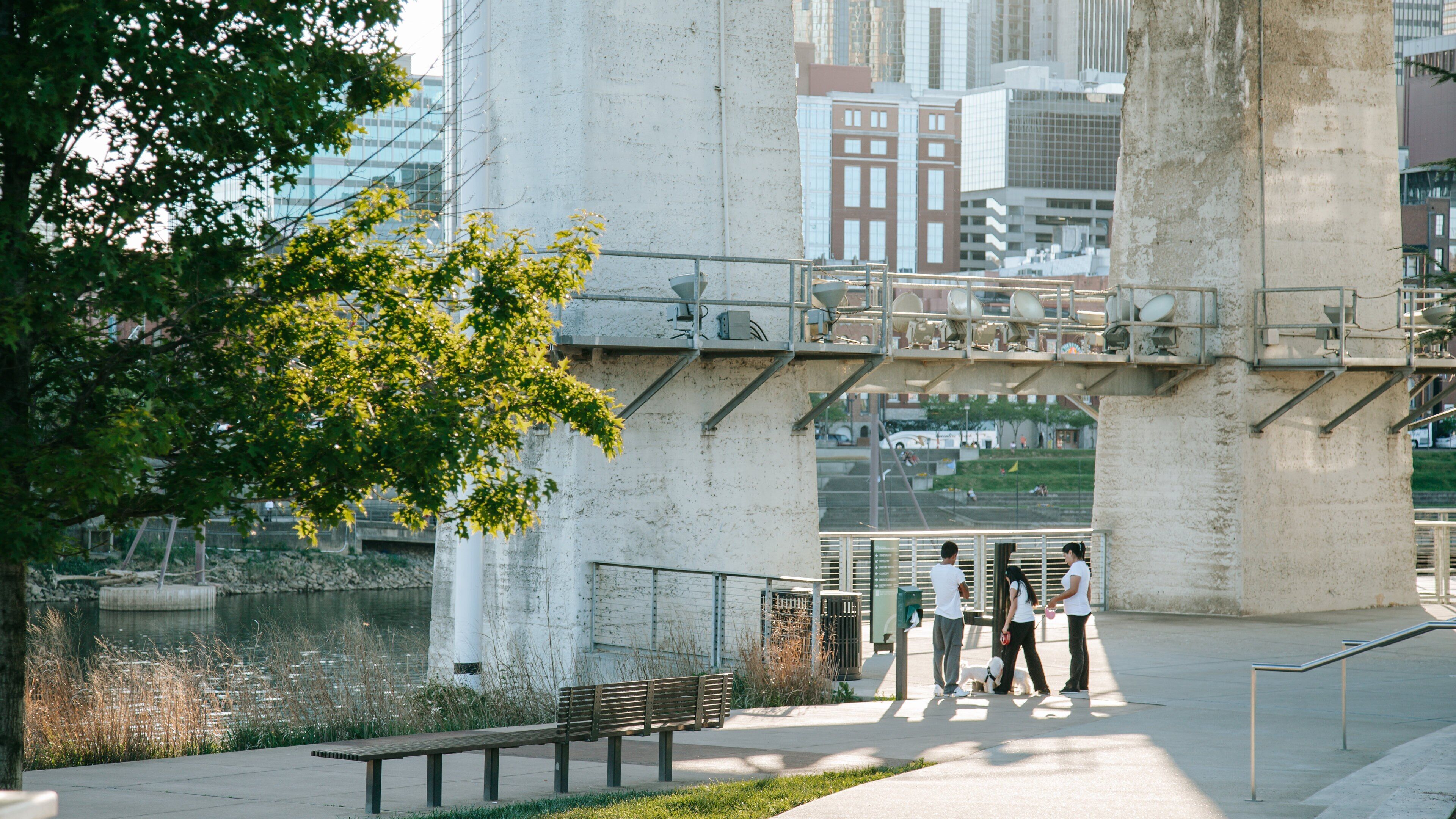 Cumberland Park featuring a city and a bridge as well as a small group of people