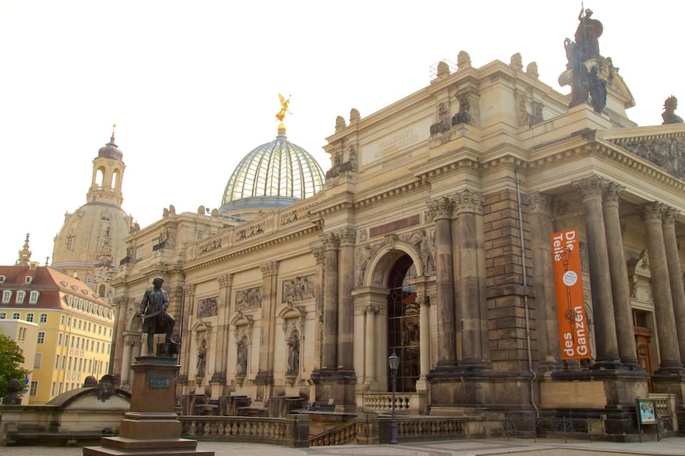 A historic building with ornate architecture, including statues and a dome.
