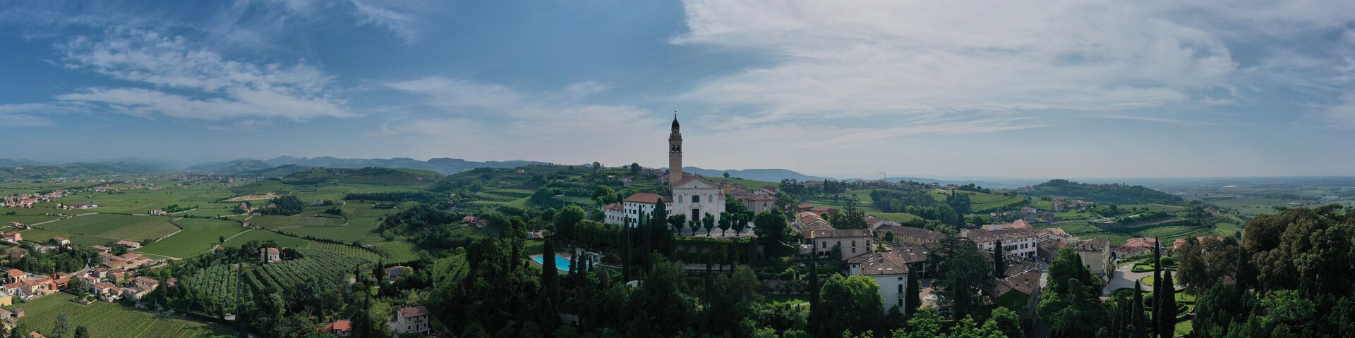 Panorama Parish Church of Saints Fermo and Rustico, on a hill in the province of Verona, Colognola Ai Colli, Italy. Italian historic town on a hill. Catholic church on a hill surrounded by vineyards