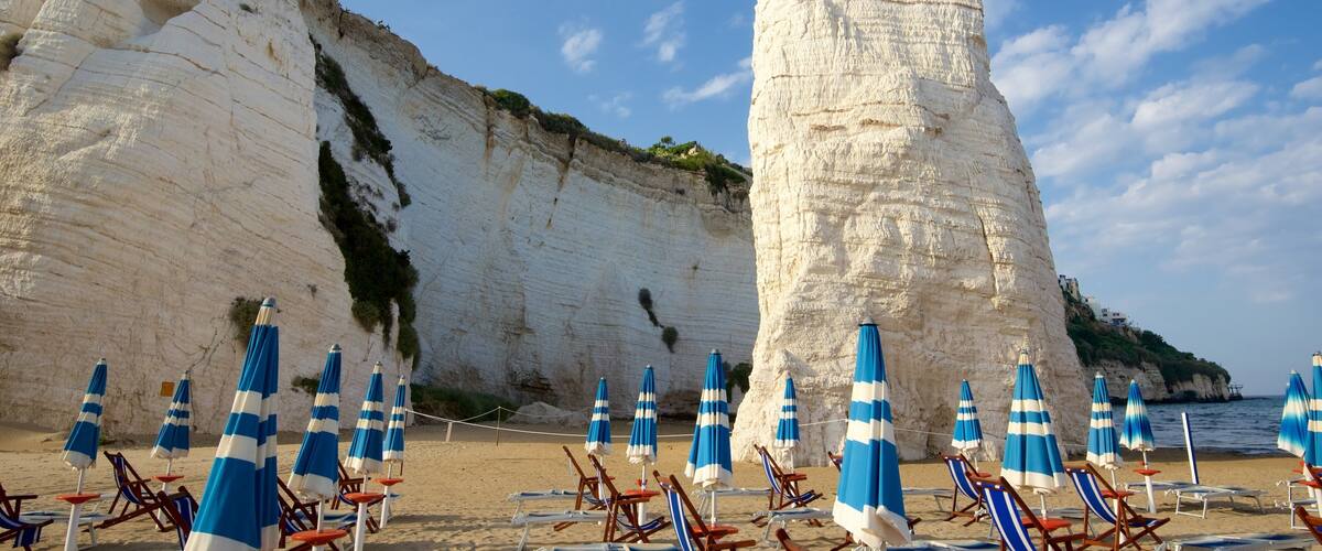 Pizzomuou which includes a beach and rocky coastline