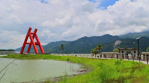 Taiwan - Aug 11, 2025: Dapu Lakeside Park connected to Lovers Park via Tongxin Suspension Bridge at Tsengwen Reservoir, featuring green lawns and scenic lake views.
