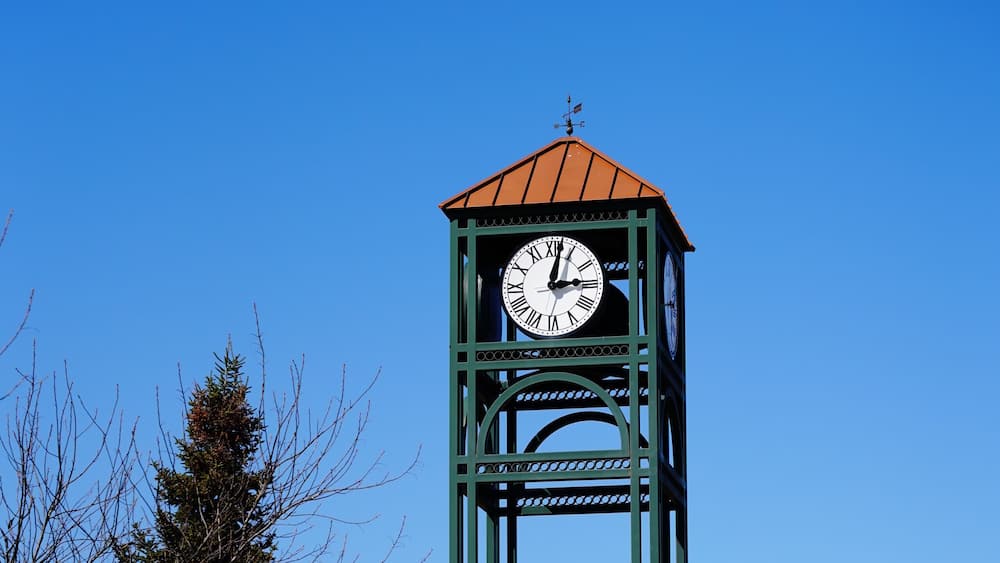 The green modern clock tower stands near Plover, Wisconsin shopping business district.
