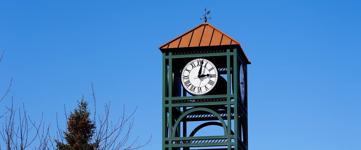 The green modern clock tower stands near Plover, Wisconsin shopping business district.