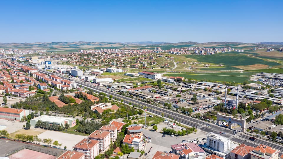 A cityscape with a prominent highway, residential areas, and industrial zones.