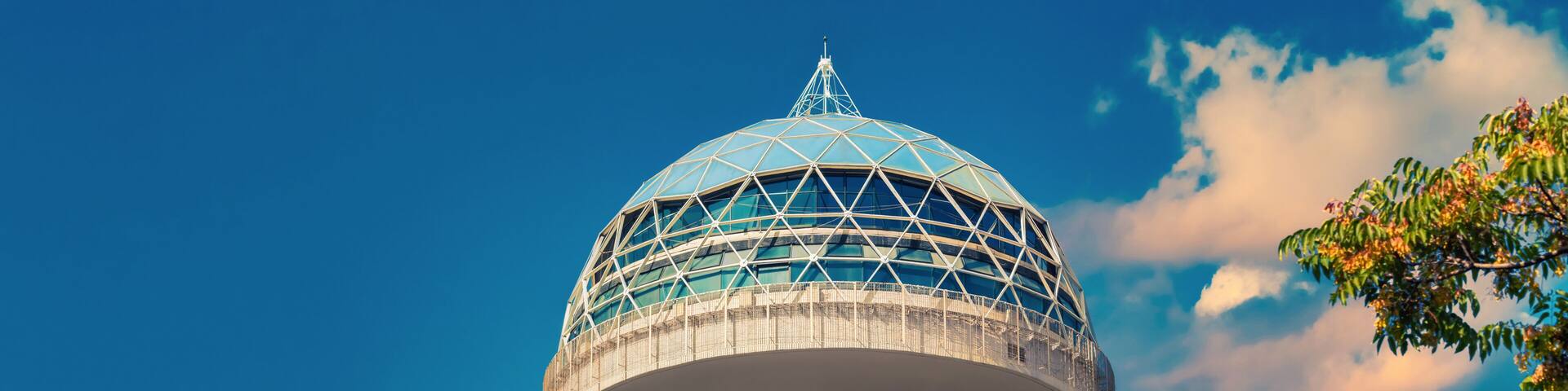 Atakule behind the branches. Symbol of Ankara in front of sky. Popular touristic landmark of the capital city with 125m height. Ufo shaped dome is an example of modern architecture.